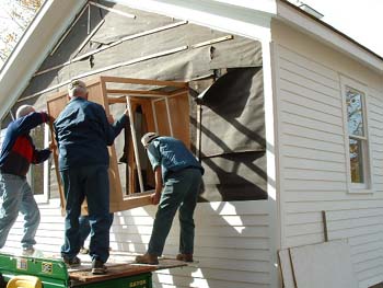 098 - Cabinet being eased into schoolhouse