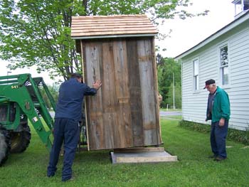 209 -Outhouse being positioned on slab